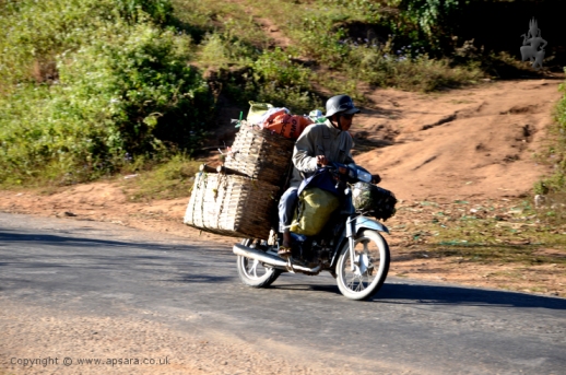 A trader with his motorbike loaded with goods on his way to Mogok...